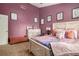 Comfortable bedroom featuring unique wall art, complemented by a cozy bench and a decorative array of pillows at 1221 Overton Dr, Lawrenceville, GA 30044