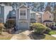 Charming two-story townhome featuring a one-car garage and well-maintained landscaping at 1221 Overton Dr, Lawrenceville, GA 30044