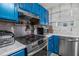 Updated kitchen with a modern stainless steel stove and blue cabinets at 1221 Overton Dr, Lawrenceville, GA 30044