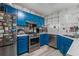 Updated kitchen features stainless steel appliances and vibrant blue cabinetry at 1221 Overton Dr, Lawrenceville, GA 30044