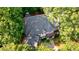 Overhead view of a home with a large roof, surrounded by lush green trees at 1412 Lanier Ne Mnr, Atlanta, GA 30319