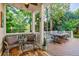 Covered back porch with seating area for relaxing and enjoying the outdoor scenery at 1412 Lanier Ne Mnr, Atlanta, GA 30319