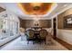Elegant dining room featuring a stunning chandelier, gold leaf ceiling, and large arched window at 1412 Lanier Ne Mnr, Atlanta, GA 30319