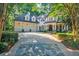 Charming home with mature trees, and well-maintained landscaping enhance curb appeal at 1412 Lanier Ne Mnr, Atlanta, GA 30319