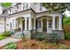 Close up of the elegant front porch with stone accents and decorative columns at 1412 Lanier Ne Mnr, Atlanta, GA 30319
