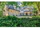 Stunning brick home with manicured landscaping, three car garage, and covered front porch at 1412 Lanier Ne Mnr, Atlanta, GA 30319