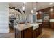 Open kitchen with a large island, farmhouse sink, granite counters, and dark wood cabinets, open to the living room at 1412 Lanier Ne Mnr, Atlanta, GA 30319