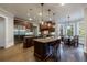 Beautiful kitchen with dark wood cabinets, stainless steel appliances, and a breakfast table near a wall of windows at 1412 Lanier Ne Mnr, Atlanta, GA 30319