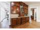 Kitchen with dark wood cabinets and granite countertops and bar area, leading to other rooms in the house at 1412 Lanier Ne Mnr, Atlanta, GA 30319