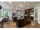 Bright kitchen featuring a large island, farmhouse sink, granite counters, and wood floors, and an adjacent table at 1412 Lanier Ne Mnr, Atlanta, GA 30319