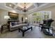 Elegant living room with coffered ceilings, stone fireplace, and french doors leading to the outdoor deck at 1412 Lanier Ne Mnr, Atlanta, GA 30319