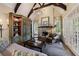 Elegant living room featuring a stone fireplace, exposed beams, and access to a patio at 1412 Lanier Ne Mnr, Atlanta, GA 30319