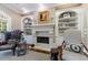 Cozy living room with a stone fireplace, built-in bookshelves, and a comfortable wingback chair at 1412 Lanier Ne Mnr, Atlanta, GA 30319