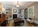 Charming living room with built-ins, fireplace, and ample natural light at 1412 Lanier Ne Mnr, Atlanta, GA 30319