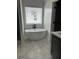 Bathroom displaying soaking tub, bright window, and modern vanity at 1522 Reserve Glen Dr, Lawrenceville, GA 30043