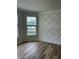 Stylish bedroom with elegant wall trim, hardwood floors, and natural light from windows at 1522 Reserve Glen Dr, Lawrenceville, GA 30043
