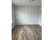 Bedroom featuring wood-look flooring and modern paneled wall at 1522 Reserve Glen Dr, Lawrenceville, GA 30043
