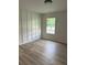 Neutral bedroom featuring hardwood floors, recessed lighting, and simple wall trim at 1522 Reserve Glen Dr, Lawrenceville, GA 30043