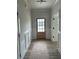 Beautiful entryway features modern flooring, wainscoting, and a lovely wood front door at 1522 Reserve Glen Dr, Lawrenceville, GA 30043