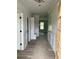 Bright hallway featuring modern flooring, wainscoting, and a convenient mudroom area at 1522 Reserve Glen Dr, Lawrenceville, GA 30043