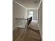 Hallway featuring decorative railing and wood-look flooring leading to other rooms at 1522 Reserve Glen Dr, Lawrenceville, GA 30043