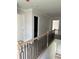 Hallway with decorative railing and wood flooring leading to other rooms at 1522 Reserve Glen Dr, Lawrenceville, GA 30043