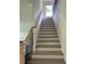 Elegant staircase with wooden handrail and iron balusters, providing access to the second floor at 1522 Reserve Glen Dr, Lawrenceville, GA 30043
