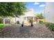 A view of the backyard with a shed, sunroom, grass, and mulch at 1602 Buckingham Place Pl, Woodstock, GA 30188
