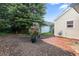 Cozy backyard with mulch ground cover, patio and mature trees offering outdoor space at 1602 Buckingham Place Pl, Woodstock, GA 30188