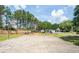 Community basketball court surrounded by mature trees with gazebo and picnic area at 1602 Buckingham Place Pl, Woodstock, GA 30188