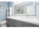Bright bathroom featuring a double vanity, large mirror, modern fixtures, and a glass-enclosed shower at 1602 Buckingham Place Pl, Woodstock, GA 30188