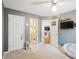 A cozy bedroom with a ceiling fan, carpet, and doors leading to the bathroom and another room at 1602 Buckingham Place Pl, Woodstock, GA 30188