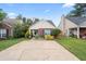 This home features a well-manicured lawn and garden, a brick facade, and a comfortable front porch at 1602 Buckingham Place Pl, Woodstock, GA 30188