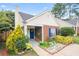 Charming home featuring a blue door and shutters, complemented by beautiful landscaping and mature trees at 1602 Buckingham Place Pl, Woodstock, GA 30188