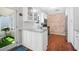 Kitchen featuring white cabinets, granite countertops, stainless steel appliances, and a brick accent wall at 1602 Buckingham Place Pl, Woodstock, GA 30188