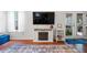 Cozy living room with hardwood floors, modern fireplace, and French doors leading to an outdoor space at 1602 Buckingham Place Pl, Woodstock, GA 30188
