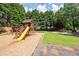 A well-maintained community playground with a slide, swings, and picnic tables at 1602 Buckingham Place Pl, Woodstock, GA 30188