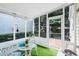 This sunroom features artificial turf, white framed screens, and access to the outside at 1602 Buckingham Place Pl, Woodstock, GA 30188