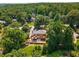 Aerial view of the home surrounded by mature trees and lush landscaping in an established neighborhood at 7575 Hunters Woods W Dr, Atlanta, GA 30350