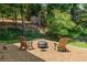 Cozy backyard area with Adirondack chairs surrounding a charming fire pit feature at 7575 Hunters Woods W Dr, Atlanta, GA 30350