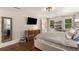 Comfortable bedroom featuring hardwood floors, a large mirror, and natural light from dual windows at 7575 Hunters Woods W Dr, Atlanta, GA 30350