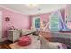 Pink bedroom features a unicorn theme, complemented by natural light from the windows at 7575 Hunters Woods W Dr, Atlanta, GA 30350