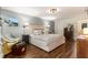Comfortable bedroom boasting hardwood floors, a stylish accent wall, and a plush bed for a relaxing retreat at 7575 Hunters Woods W Dr, Atlanta, GA 30350