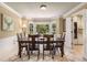 Bright dining room featuring a large bay window with tree view, with an open entrance to the kitchen at 7575 Hunters Woods W Dr, Atlanta, GA 30350