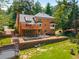 Aerial view of brick home with tiered backyard, patio, deck, trampoline, and mature trees in an established neighborhood at 7575 Hunters Woods W Dr, Atlanta, GA 30350