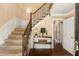 Bright foyer featuring hardwood floors, paneled walls, and staircase with wood banister at 7575 Hunters Woods W Dr, Atlanta, GA 30350