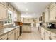 Spacious kitchen with granite countertops, light colored cabinets, and stainless steel appliances at 7575 Hunters Woods W Dr, Atlanta, GA 30350