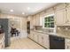 Kitchen showcases tile backsplash, tile floors, granite counters, and stainless appliances at 7575 Hunters Woods W Dr, Atlanta, GA 30350