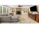Comfortable living room with stone fireplace, built in shelving, and large windows for natural light at 7575 Hunters Woods W Dr, Atlanta, GA 30350