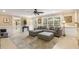 Inviting living room featuring a large sectional sofa, ceiling fan, and natural light from expansive windows at 7575 Hunters Woods W Dr, Atlanta, GA 30350